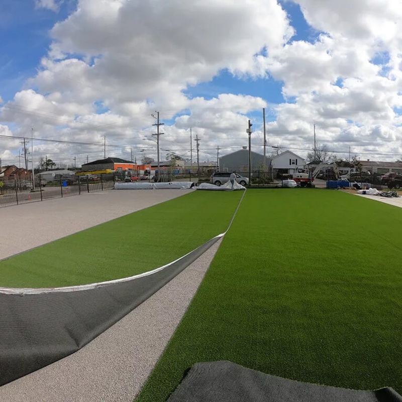 men installing the artificial turf on a playground